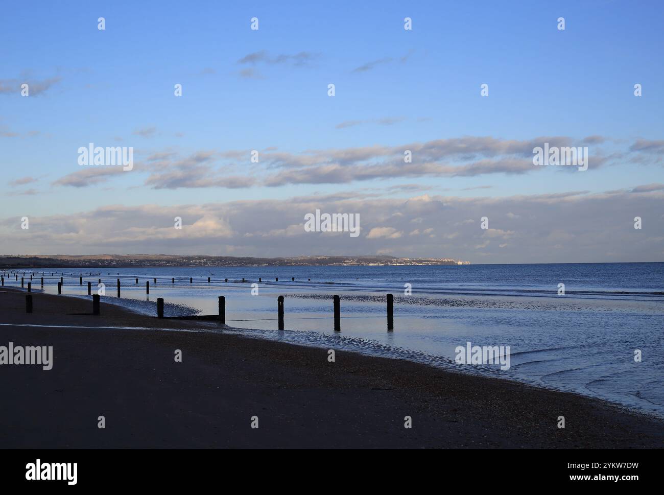 Early evening with receding tide looking towards Folkestone and Hythe from the beach at Dymchurch, Romney Marsh, Kent, England Stock Photo