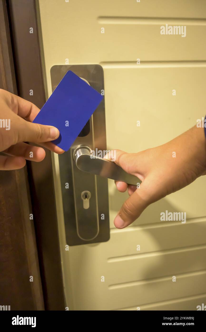 A hand inserting a blue card key into a modern hotel door lock, key electronic lock, hotel room, holidays in mallorca, spain Stock Photo