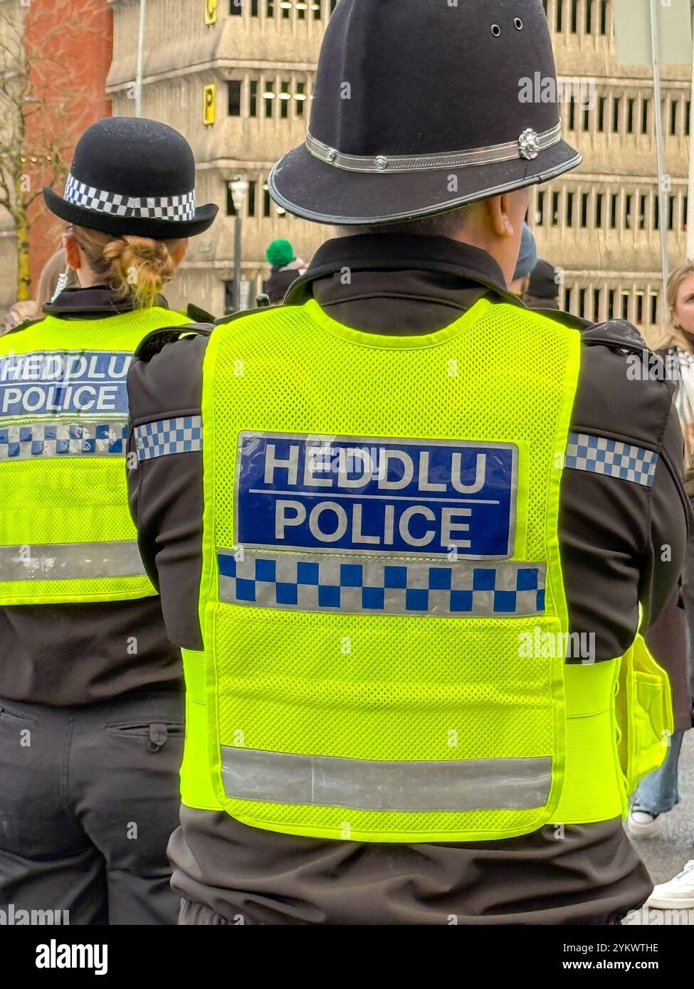 Cardiff, Wales, UK - 17 November 2024: Rear view of police officers of the South Pales Police force on duty in Cardiff city centre - Smartphone Captured Stock Image