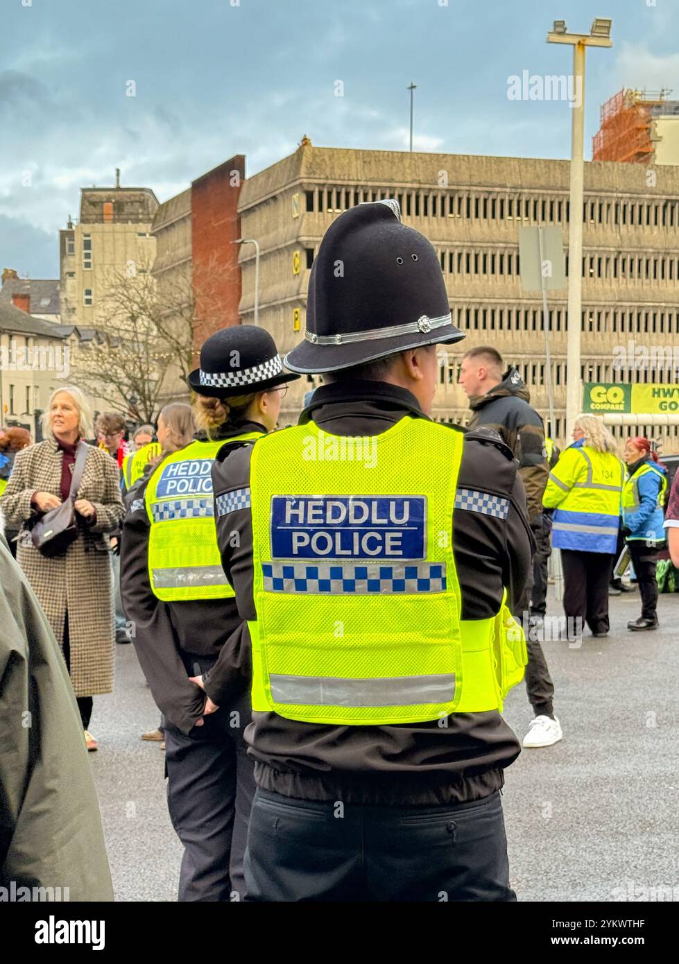 Cardiff, Wales, UK - 17 November 2024: Rear view of police officers of the South Pales Police force on duty in Cardiff city centre - Smartphone Captured Stock Image