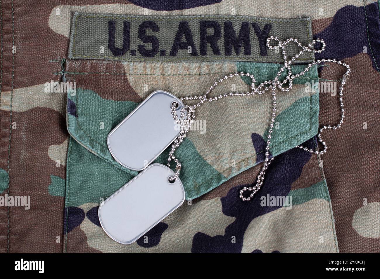 Tag System Army US ARMY branch tape and dog tags on woodland camouflage uniform ...
