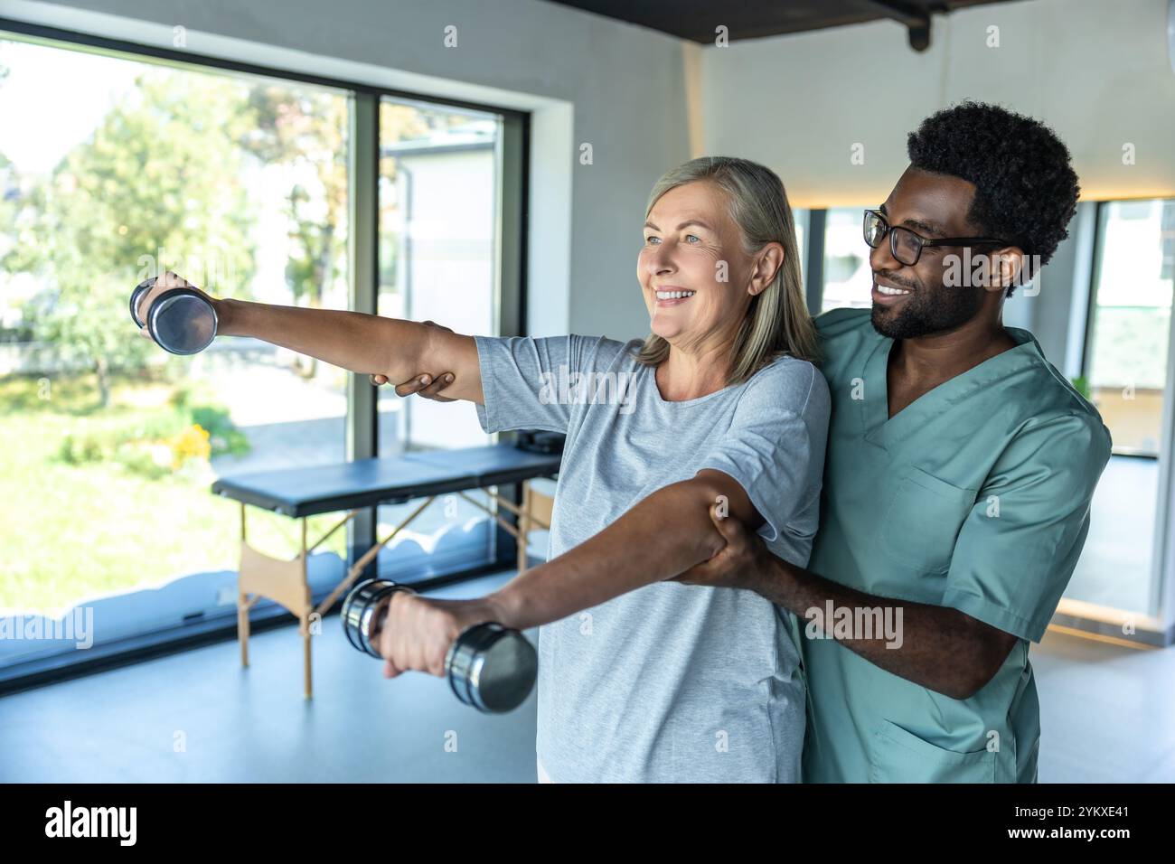 African american doctor having rehabilitation exercises with a female ...