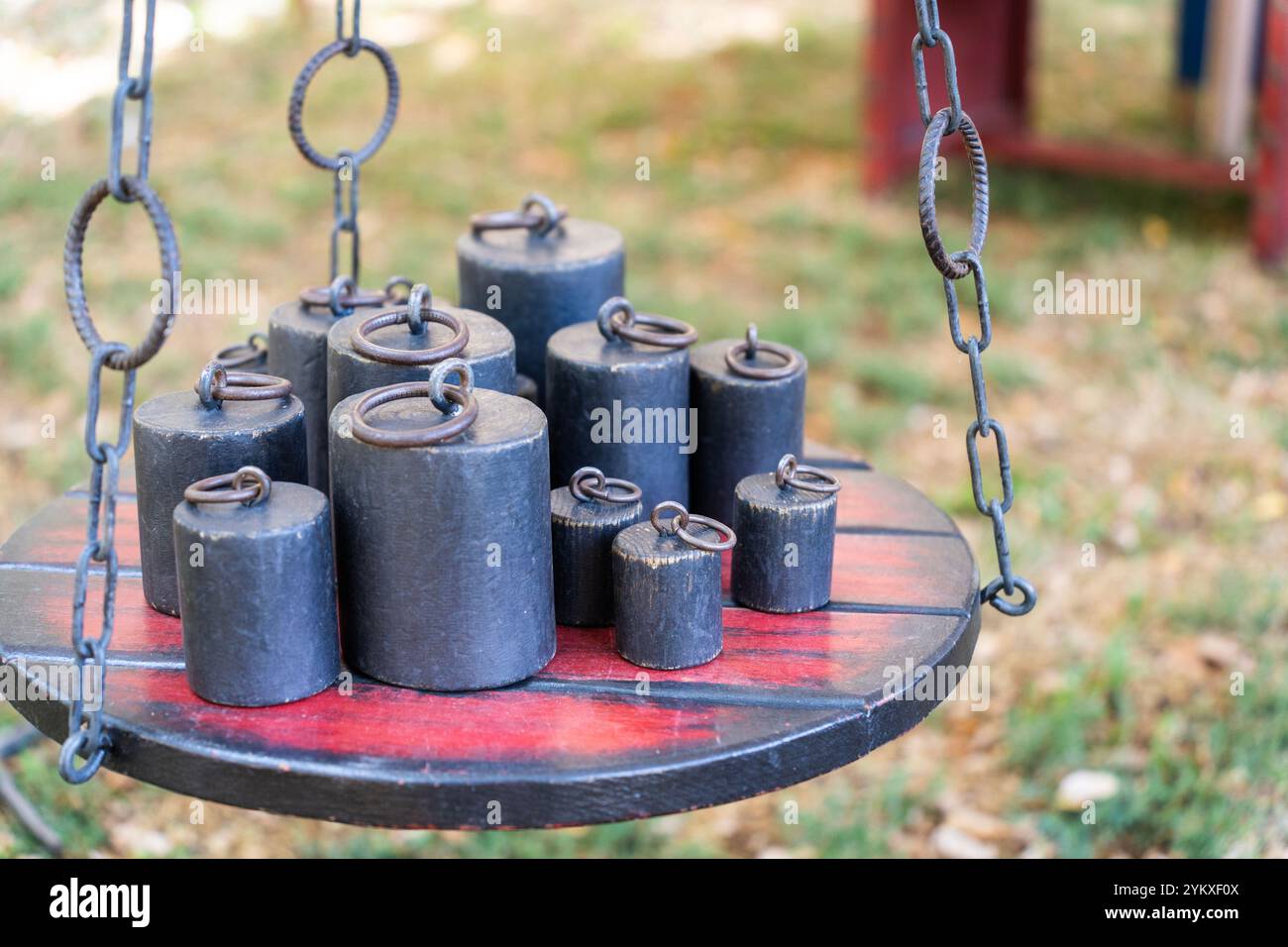 Old-fashioned iron weights on an old scale Stock Photo