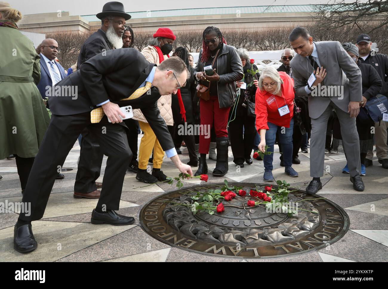 Attendees lay roses at the center of the National Law Enforcement ...