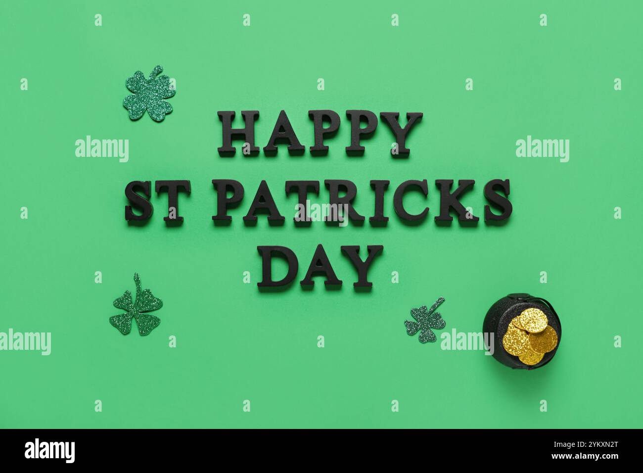 Words HAPPY ST PATRICKS DAY with pot of golden coins and clovers on ...