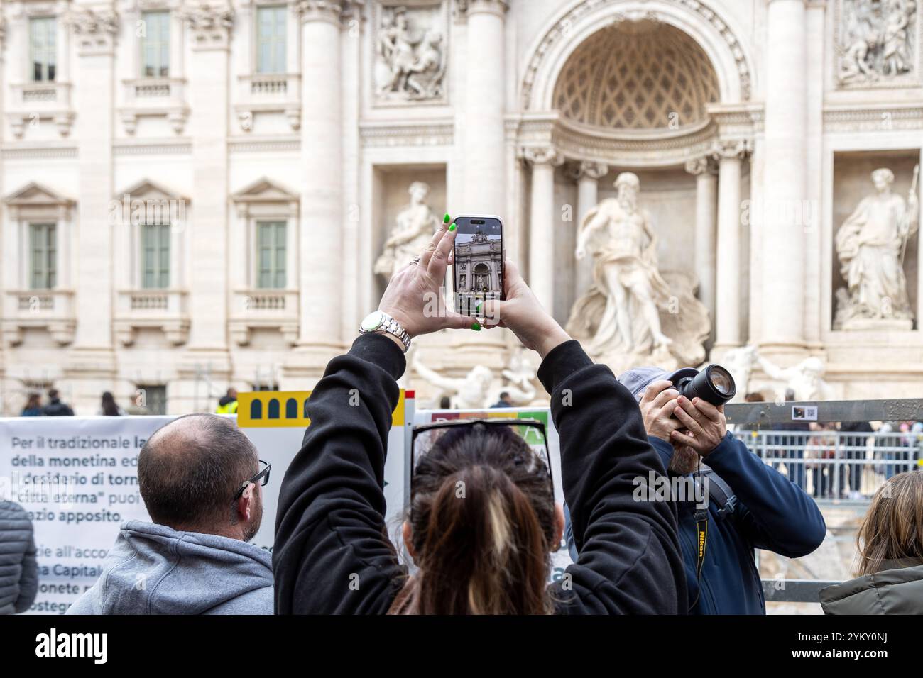 Rome, Italy - Nov 14th, 2024: A visitor photographs the Trevi Fountain ...