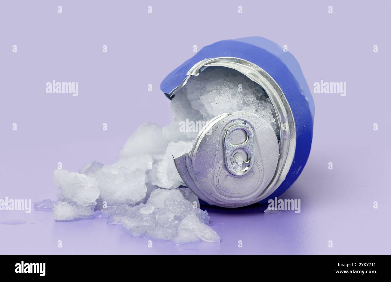 Close up of broken blue aluminum can filled with ice isolated on blue Stock Photo