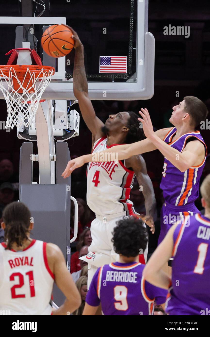 Columbus, Ohio, USA. 19th Nov, 2024. Ohio State Buckeyes forward Aaron Bradshaw (4) slams down an alley-top pass for two in front of Evansville Purple Aces forward Gabriel Pozzato (0) during the game between the Evansville Purple Aces and the Ohio State Buckeyes at Value City Arena, Columbus, Ohio. (Credit Image: © Scott Stuart/ZUMA Press Wire) EDITORIAL USAGE ONLY! Not for Commercial USAGE! Stock Photo