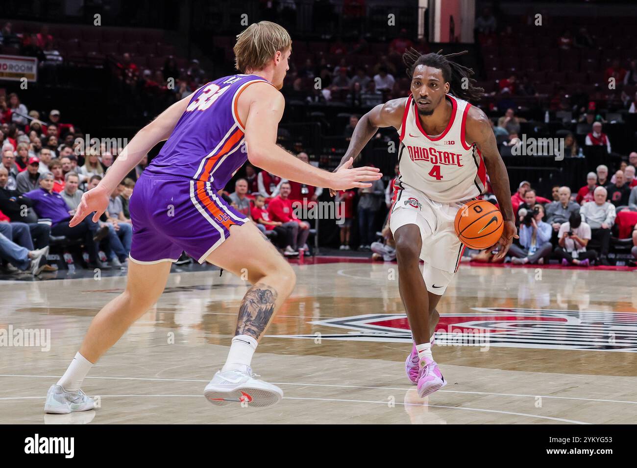 Columbus, Ohio, USA. 19th Nov, 2024. Ohio State Buckeyes forward Aaron Bradshaw (4) drives against Evansville Purple Aces center Michael Day (33) at the top of the key during the game between the Evansville Purple Aces and the Ohio State Buckeyes at Value City Arena, Columbus, Ohio. (Credit Image: © Scott Stuart/ZUMA Press Wire) EDITORIAL USAGE ONLY! Not for Commercial USAGE! Stock Photo