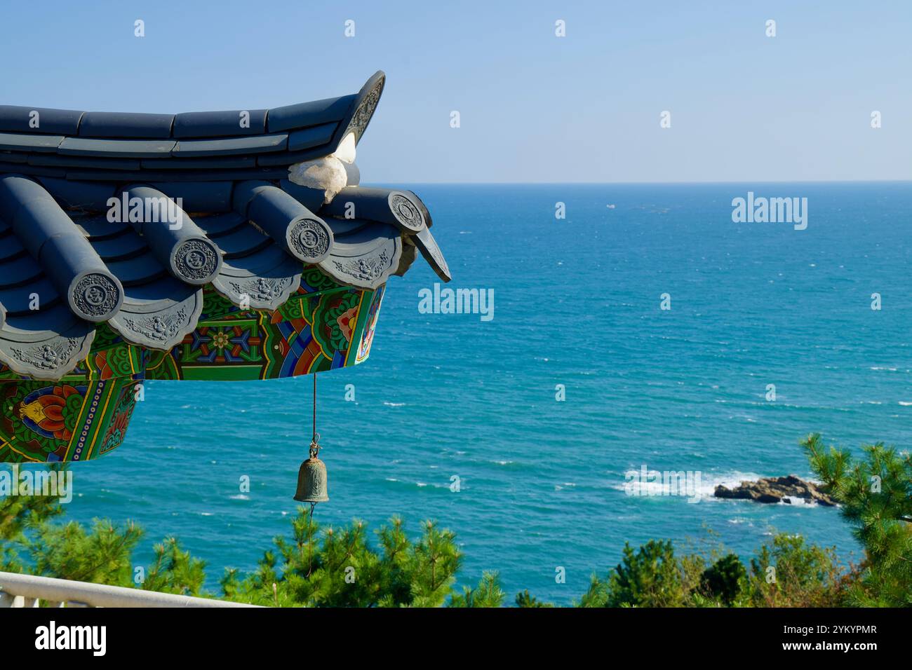 Yangyang County, South Korea - November 3rd, 2024: The ornate corner of a traditional Korean hip-and-gable roof with a decorative bell hangs above the Stock Photo