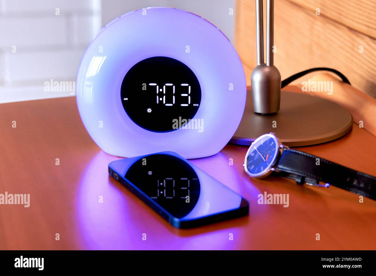 A digital alarm clock with a smartphone and watch Stock Photo - Alamy