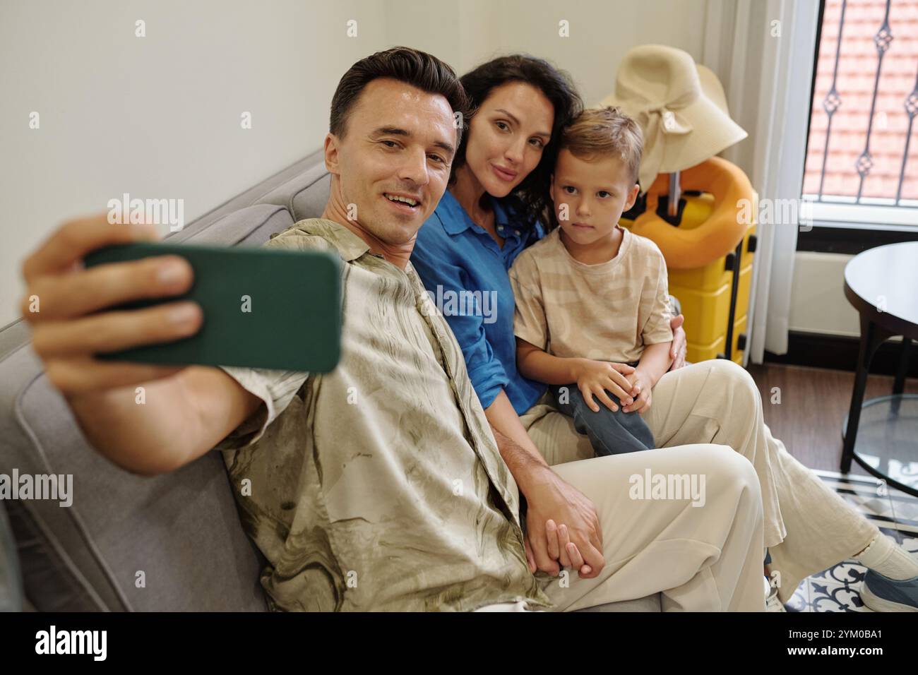 Taking Family Selfie on Comfortable Couch Stock Photo
