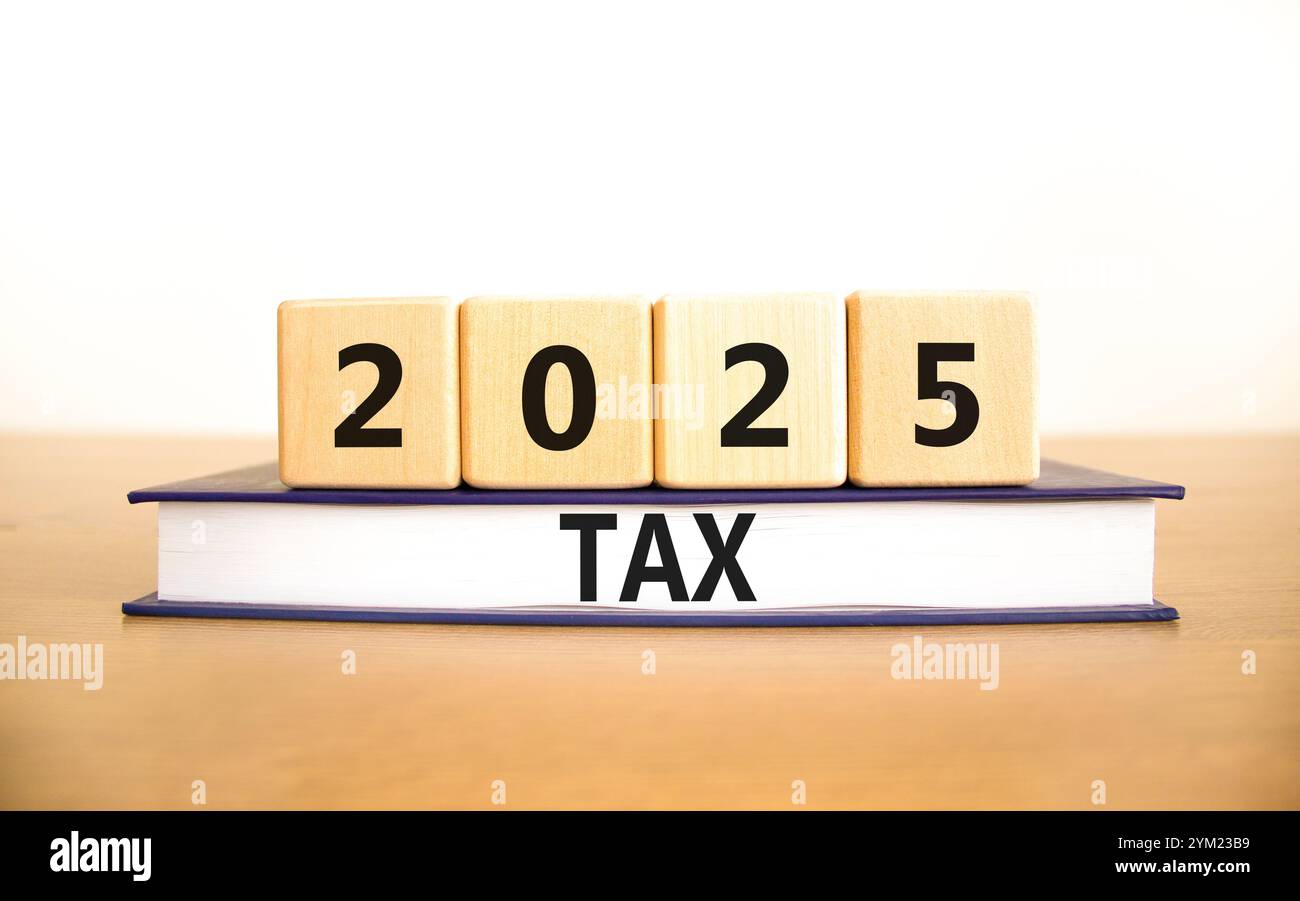 Planning 2025 tax new year symbol. Concept words 2025 Tax on beautiful wooden blocks and book