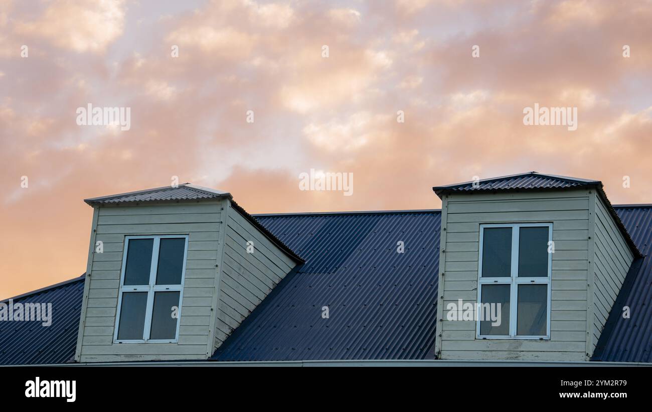 View of a dormer windows on the rooftop of a building, under a golden ...