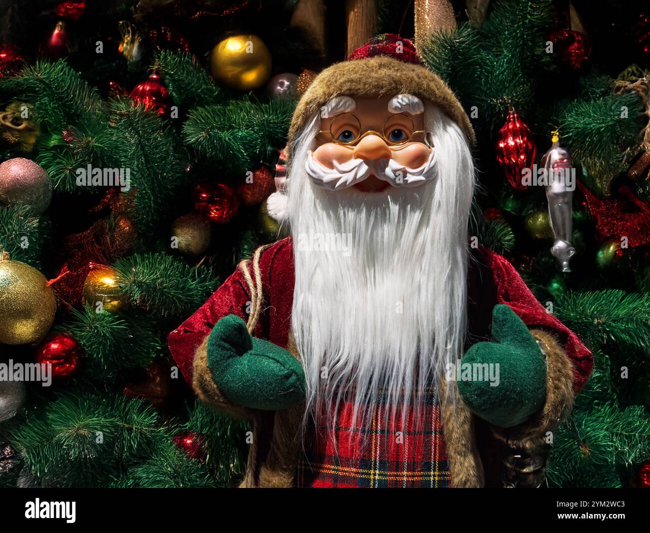 Traditional holiday Santa ornament with red and green baubles on ...