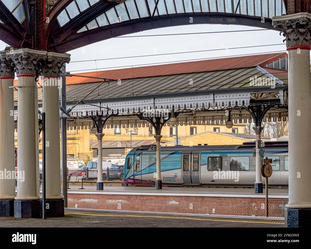 A Modern Train Stands At A Historic Railway Station Platform Under A a-modern-train-stands-at-a-historic-railway-station-platform-under-a