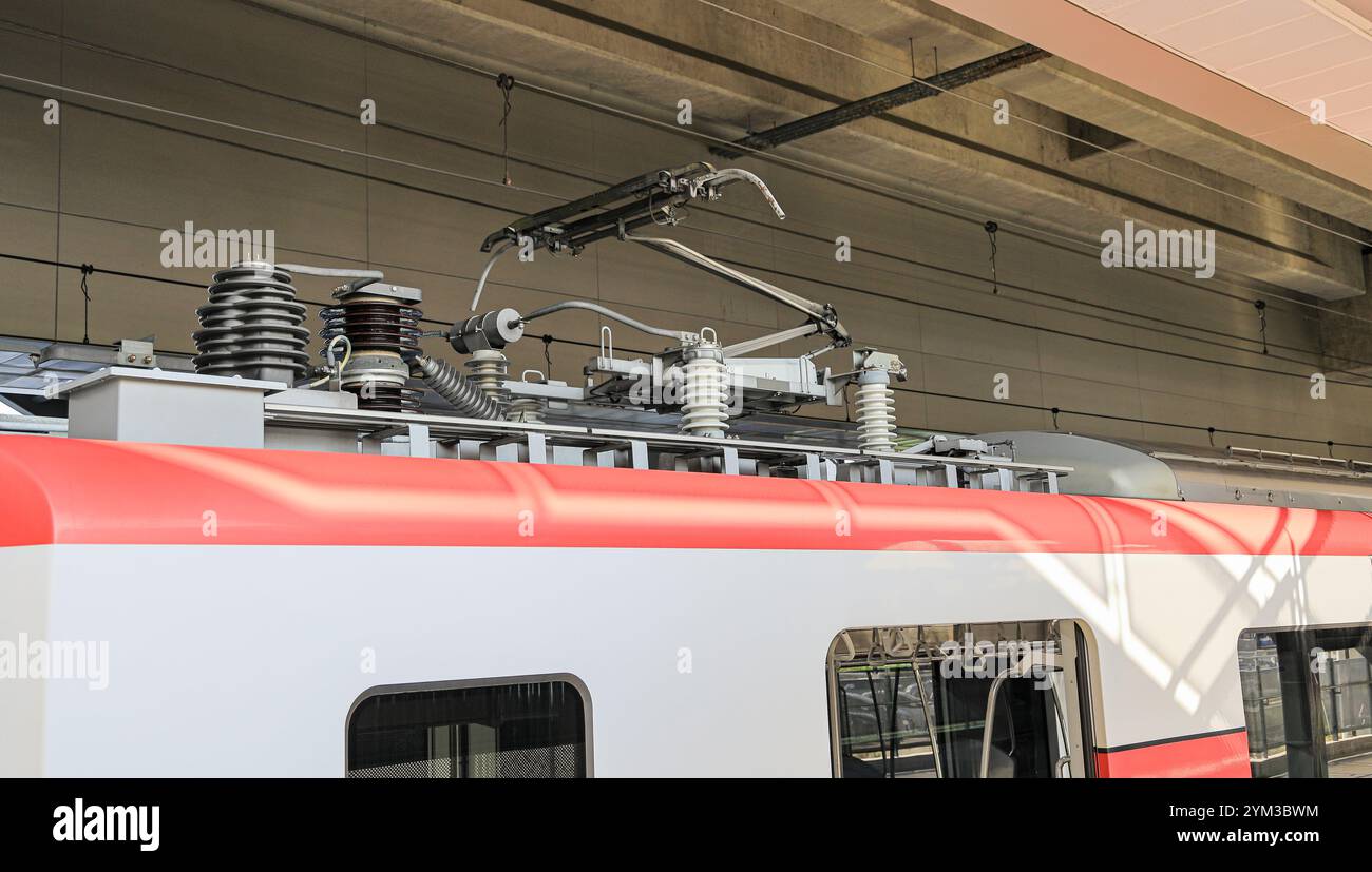 electric-rod pantograph of an electric train connecting the train to the overhead catenary wire. Stock Photo