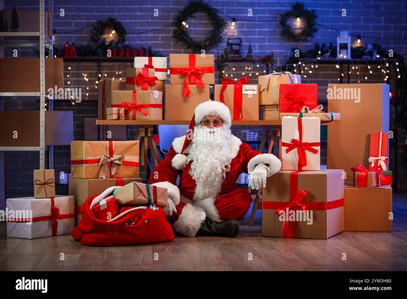 Santa Claus with many gift boxes and bag in post office Stock Photo - Alamy