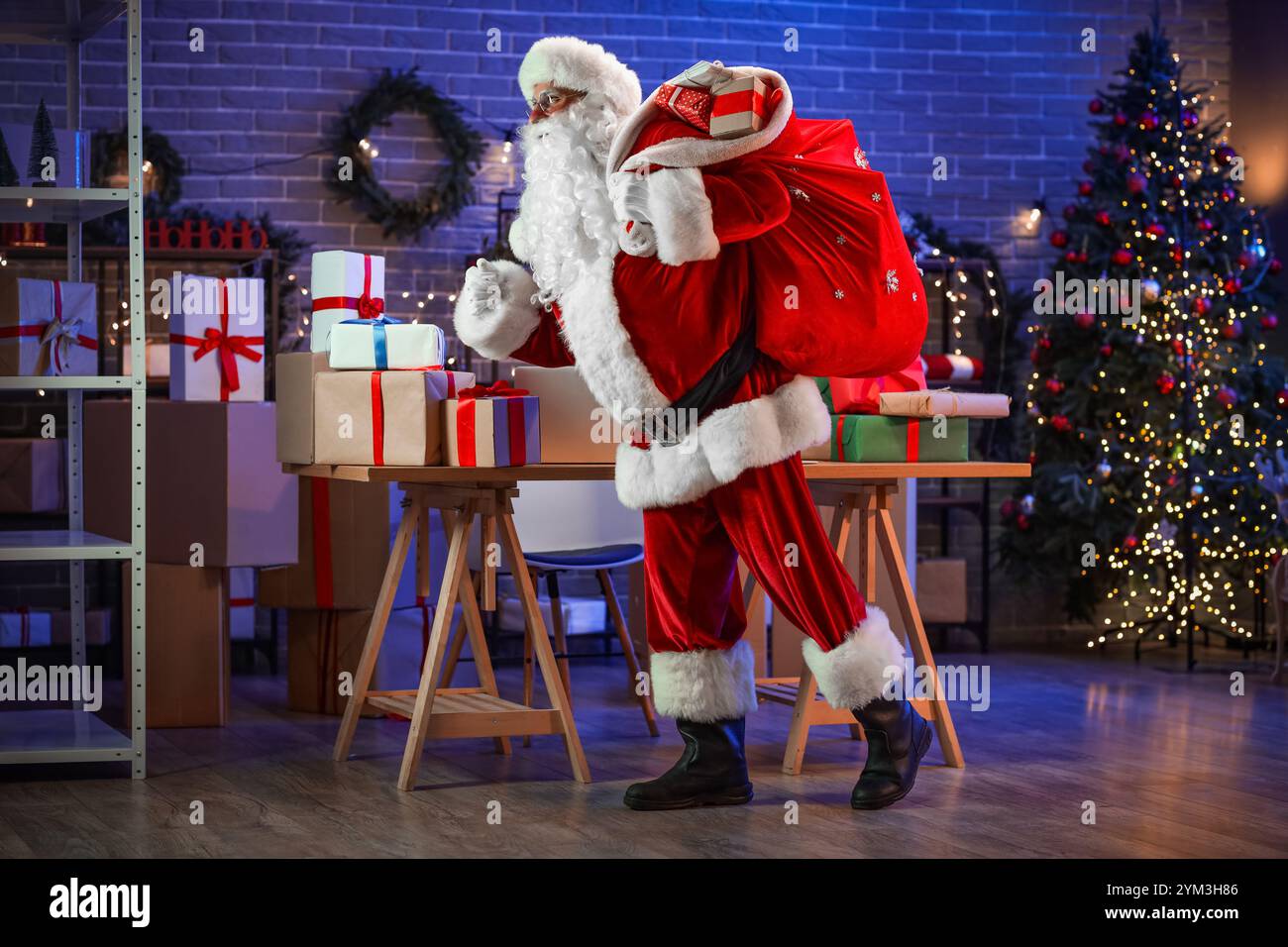 Santa Claus carrying bag of gifts in post office Stock Photo - Alamy