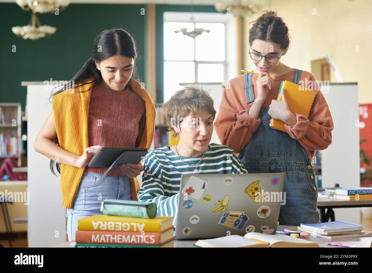 Collaborating Students Working on Laptops in Library Stock Photo