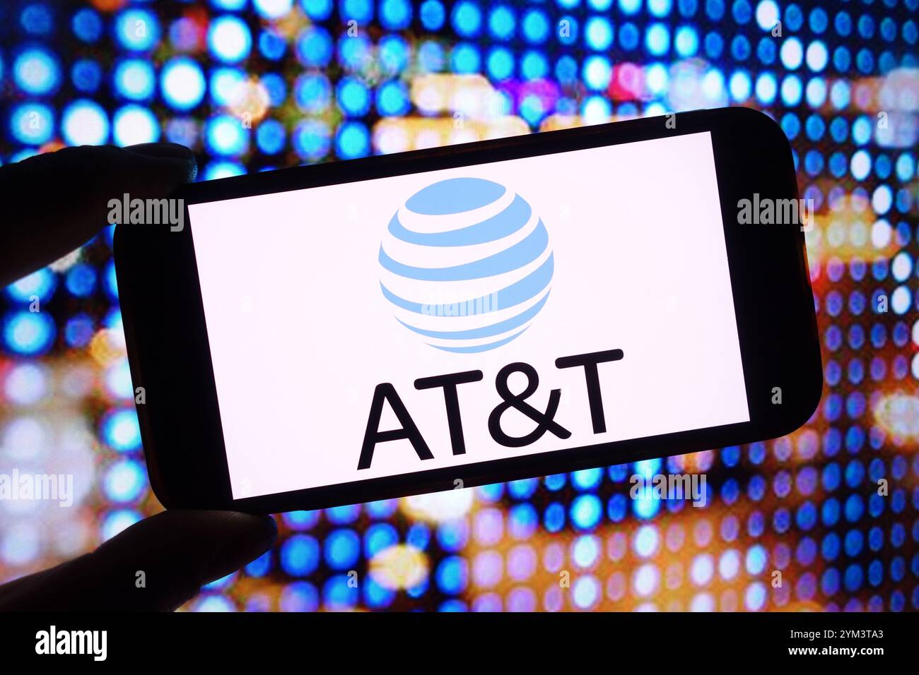 In this photo illustration, the ATT company logo is seen displayed on a ...