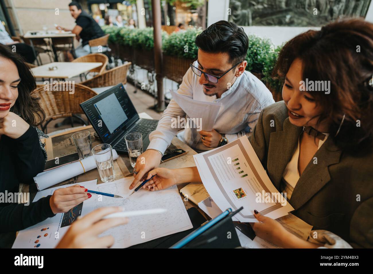 Multicultural team having a coffee meeting discussing project ideas Stock Photo