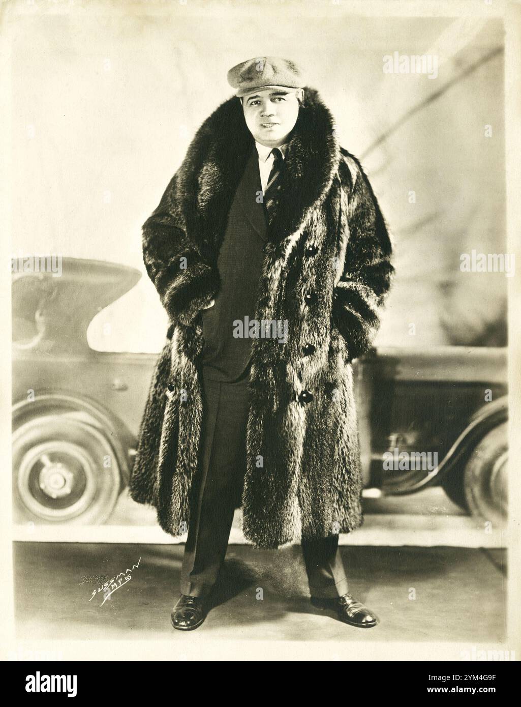 Super star and baseball legend, Babe Ruth wearing a fur coat in front ...