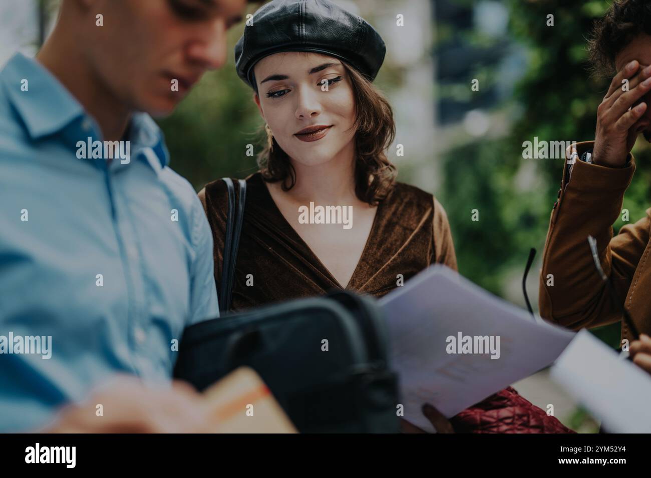 Young professionals collaborating and discussing project outdoors Stock Photo