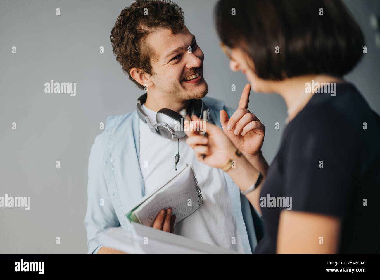 Two students happily discussing a project outdoors closeup Stock Photo