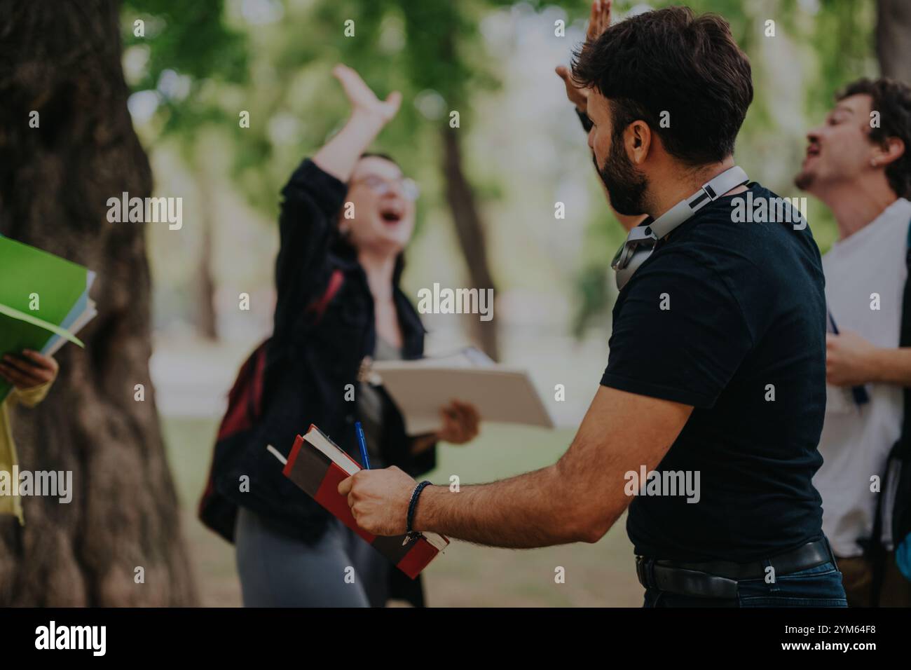 Multicultural students collaborating on a group project outdoors Stock Photo