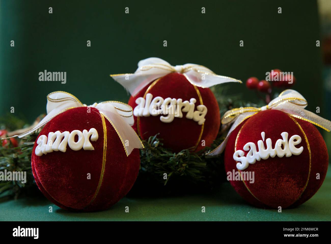 Three red velvet balls with white bows and gold trim, each with a ...