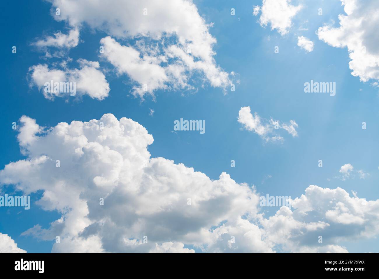 blue sky with a few clouds. The sky is very bright and the clouds are ...