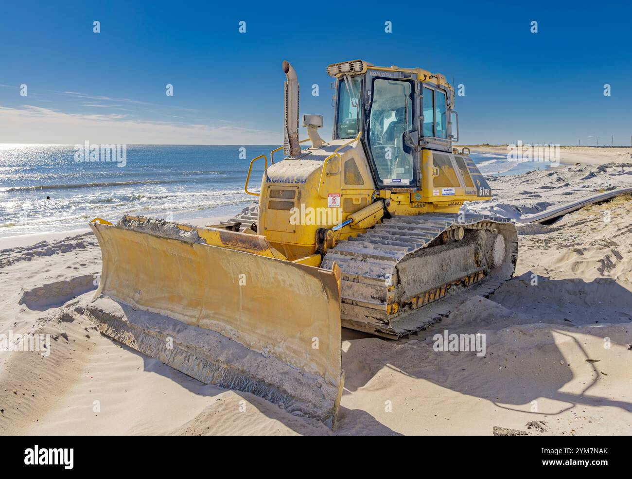 large yellow Komatsu bull dozer on ponquogue beach Stock Photo