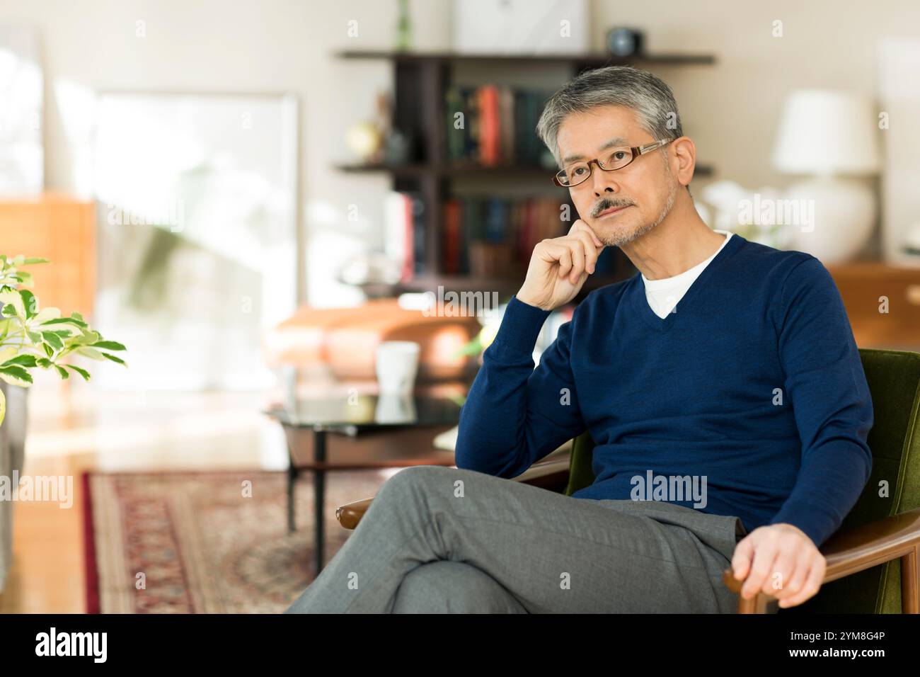 Senior man sit on sofa hi-res stock photography and images - Alamy