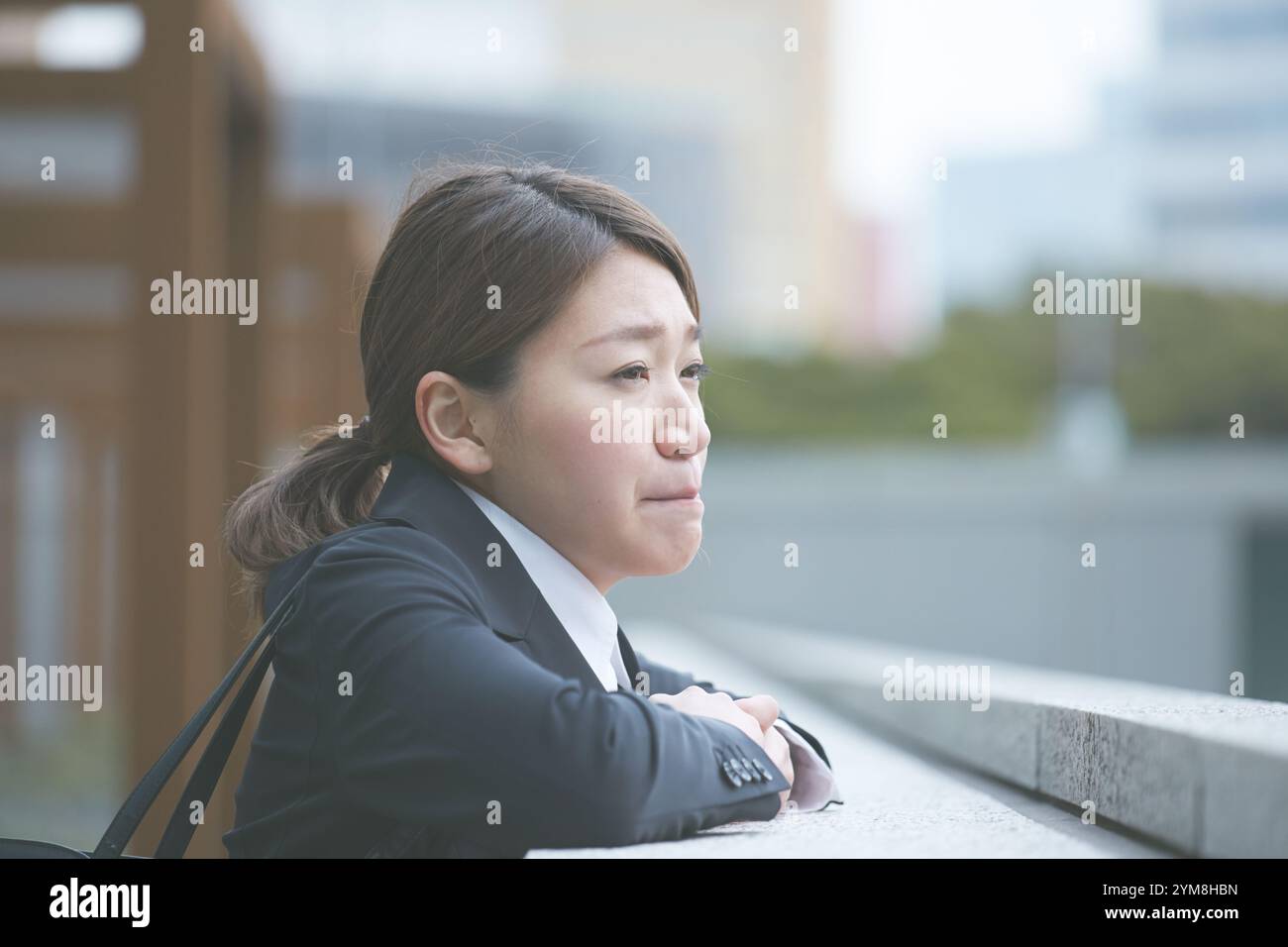 Regretfully Working woman staring regretfully into the distance Stock Photo - Alamy