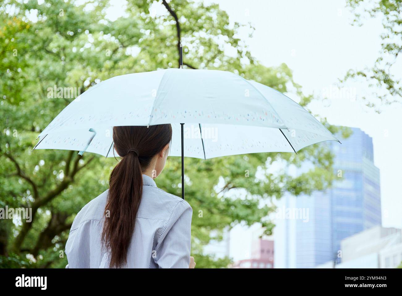 Woman with umbrella on rainy day Stock Photo - Alamy