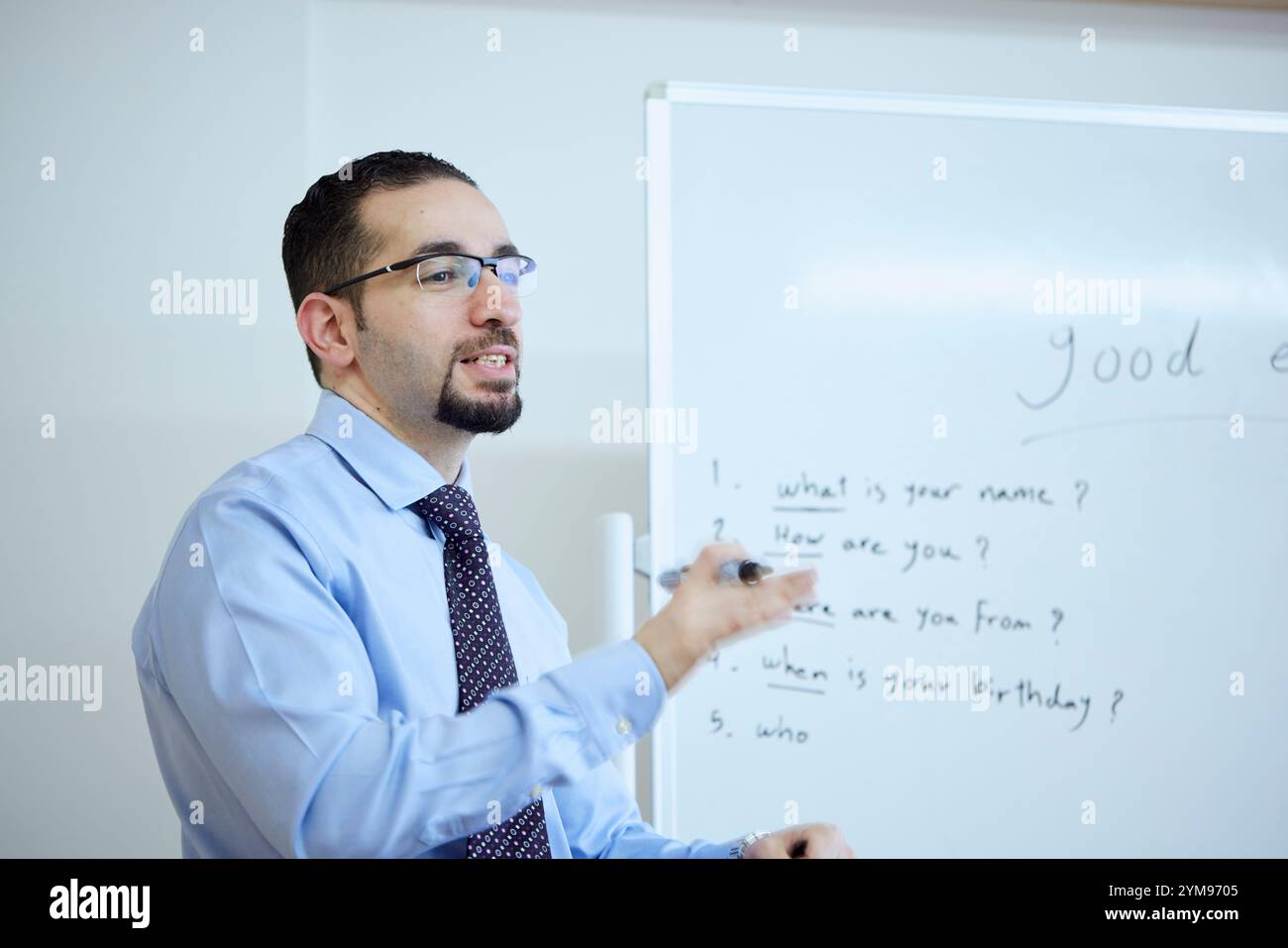 Male teacher teaching English in an English conversation class Stock Photo
