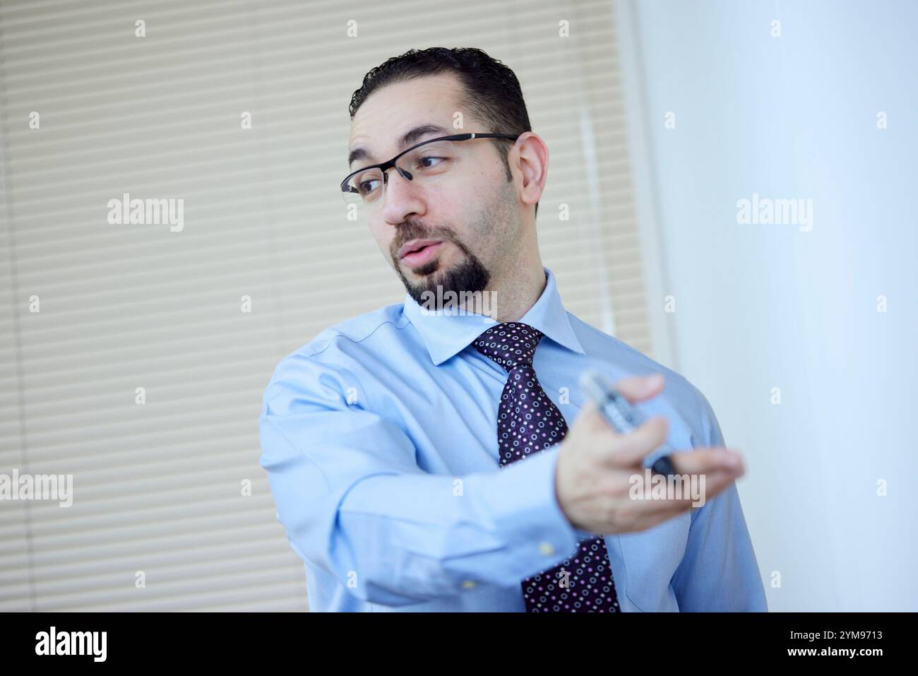 Male teacher teaching English in an English conversation class Stock Photo