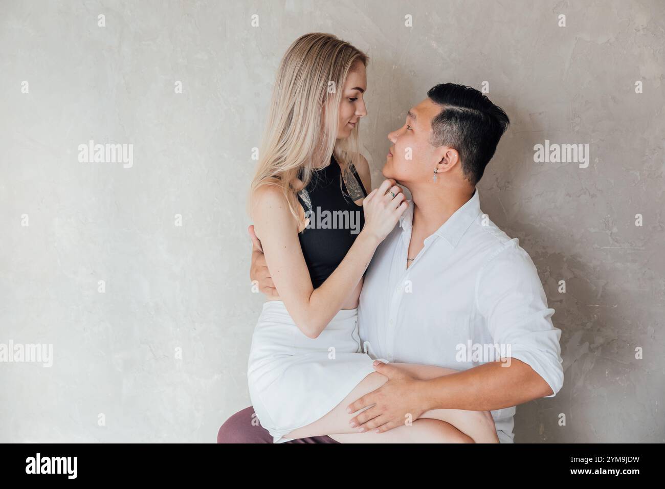 Man And Woman Sitting Together Side By Side Hugging And Smiling Stock ...