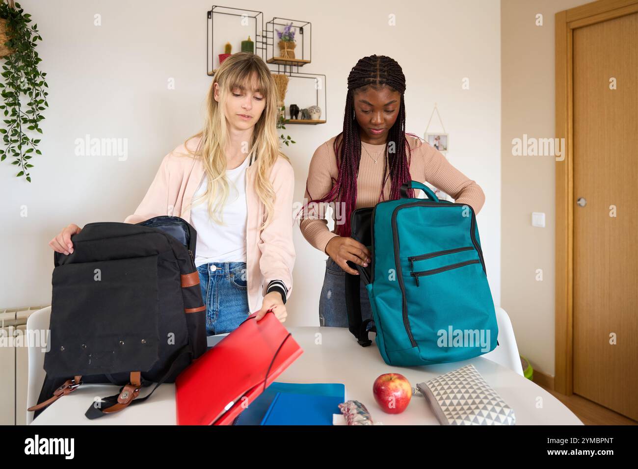 Multiethnic students preparing backpacks for university or school Stock Photo