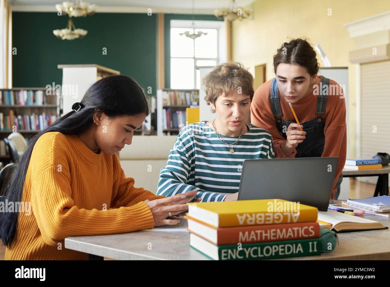 Collaborating Students Studying Together in Library Stock Photo