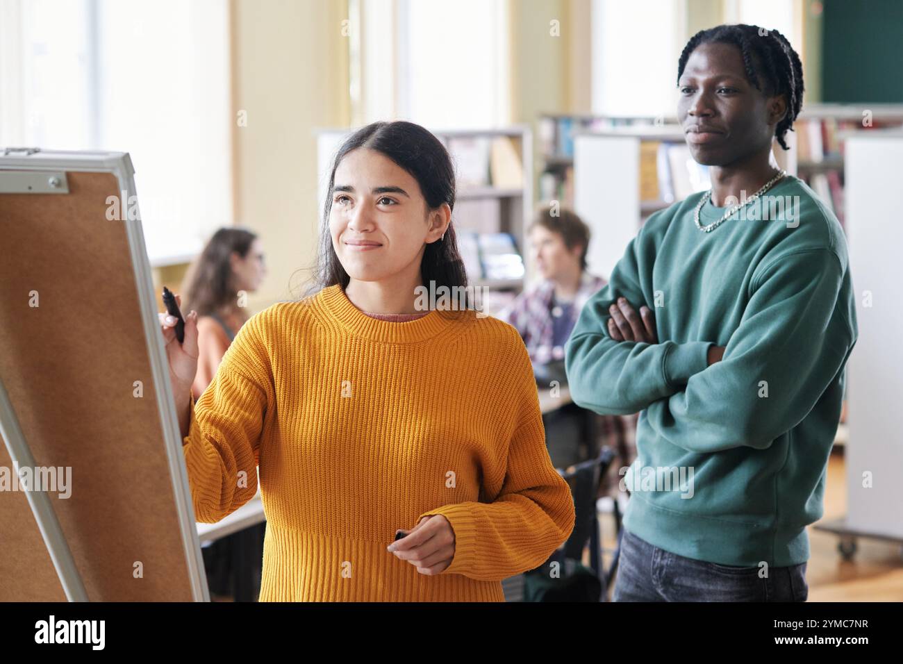 Collaborating in Classroom with Diverse Group of Students Stock Photo