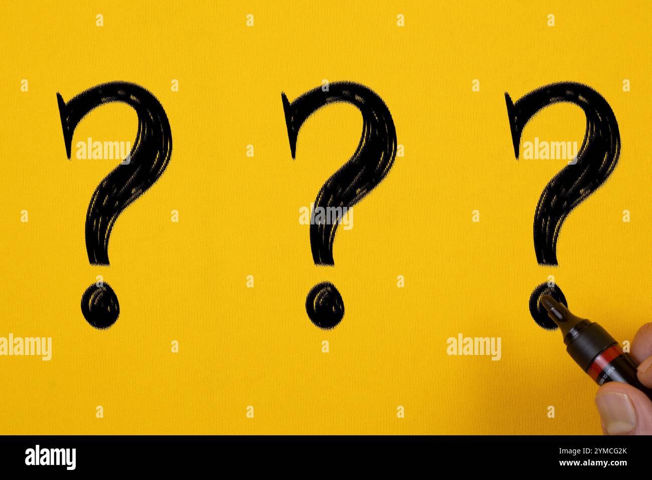 Question marks written on Yellow Background Stock Photo