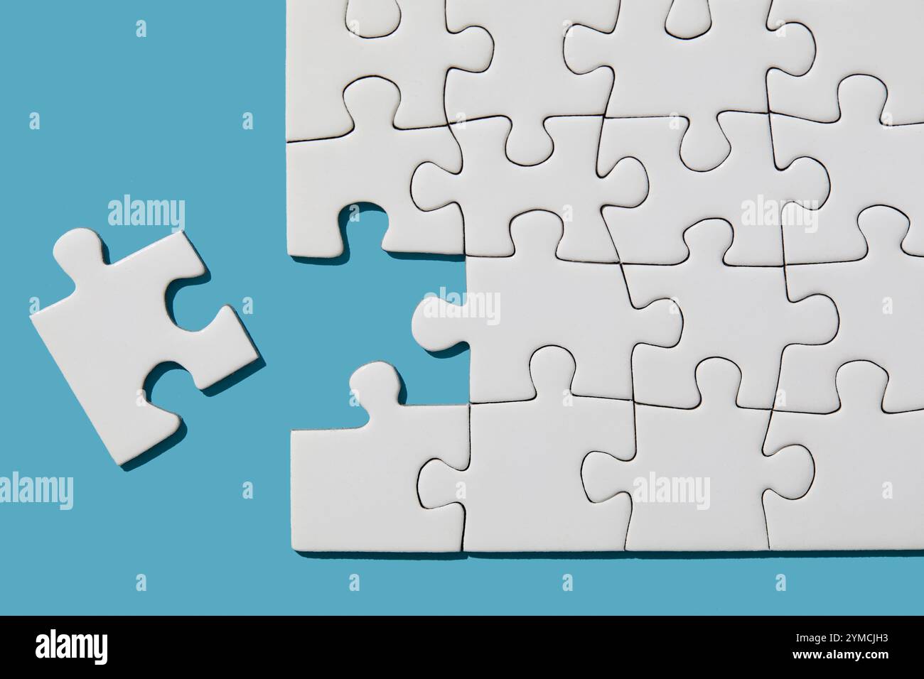 Jigsaw puzzle with missing piece on blue background Stock Photo