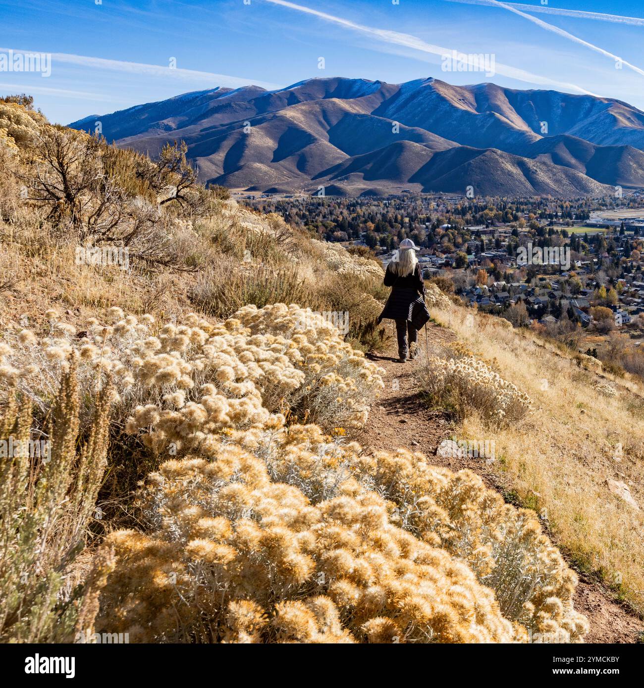 Rear view of woman hiking on Carbonate Mountain trail Stock Photo - Alamy