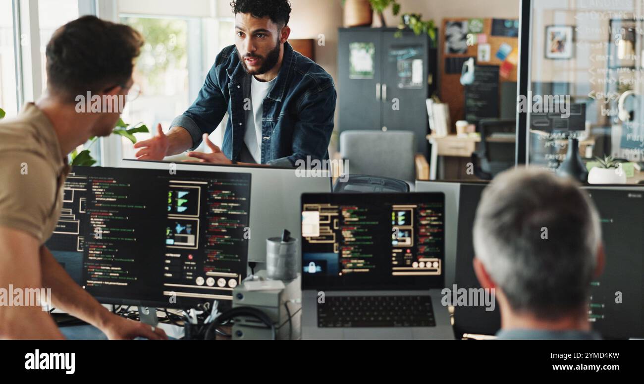 Men, discussion and programmer with computer for coding solutions, problem solving or idea at office. Male people, designers or developers working on Stock Photo