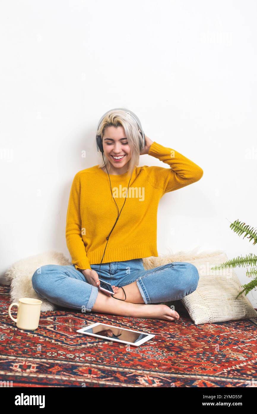 Woman in yellow sweater wearing hi-res stock photography and images - Alamy