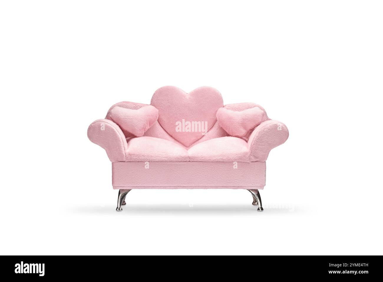 Pink velvet sofa with heart pillows isolated on white background Stock Photo