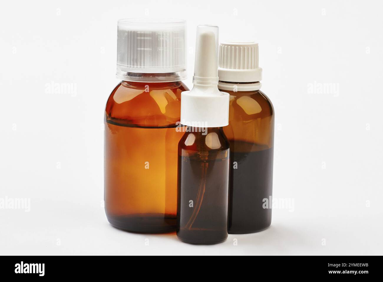 Liquid remedy in bottles. Cough syrup near nasal spray. Development of medicine Stock Photo