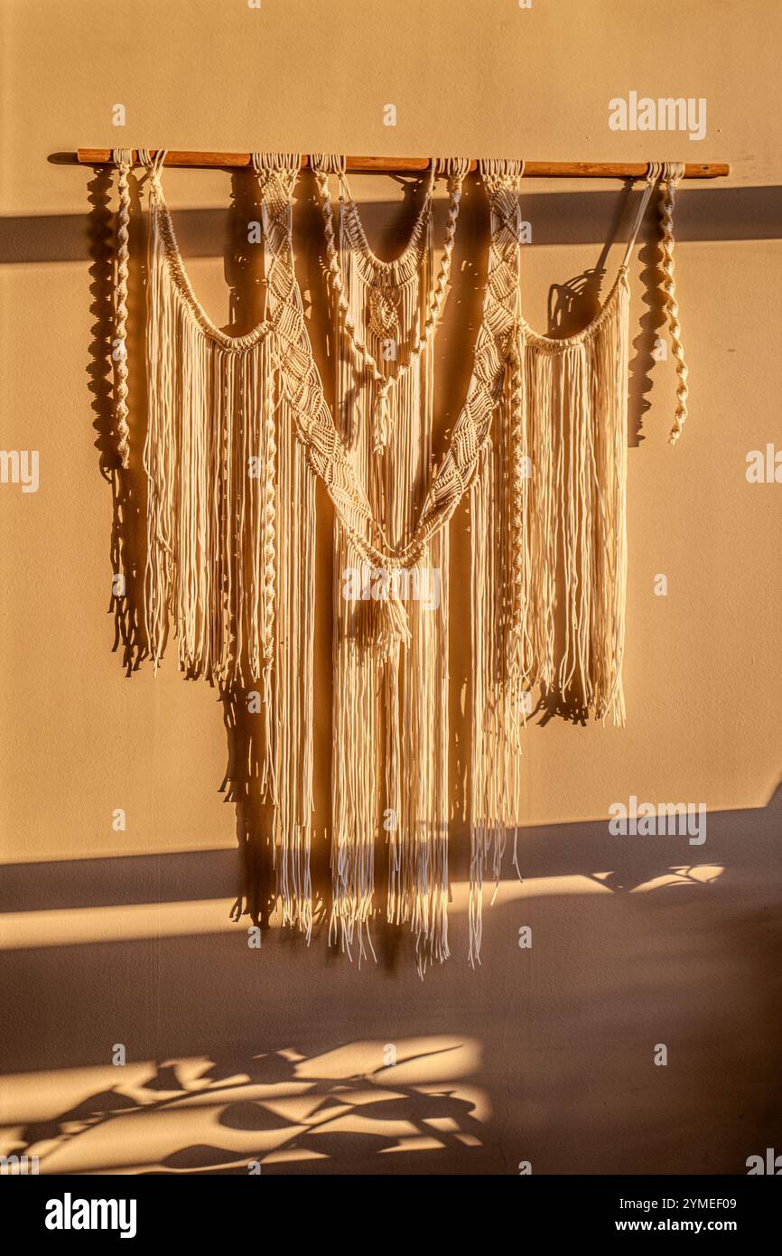 Macrame curtains in the evening light Stock Photo